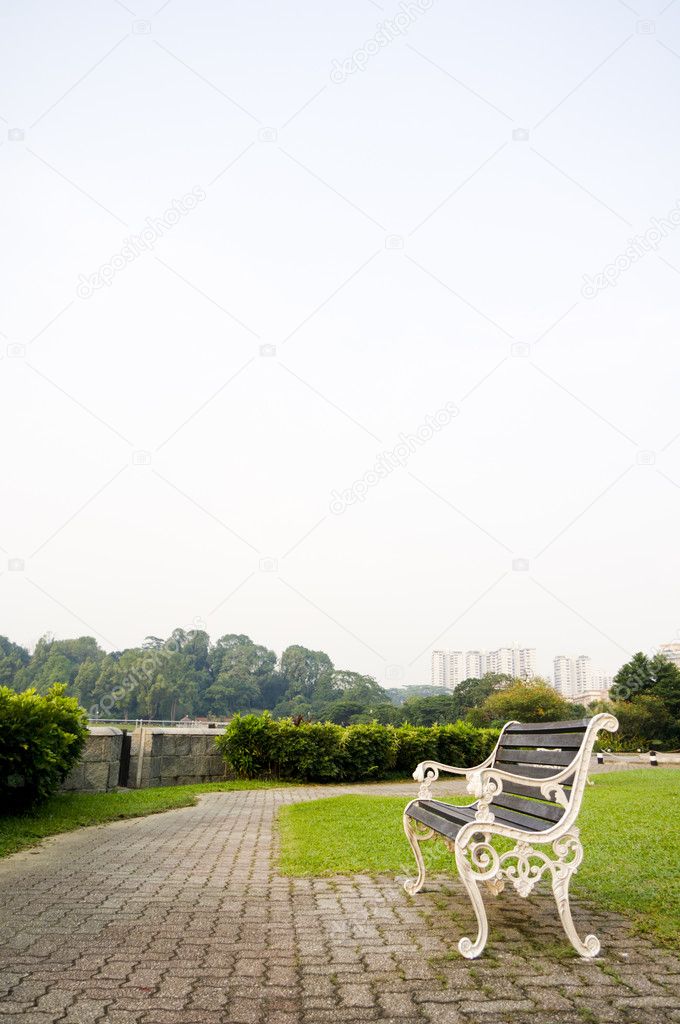 Bench in park with copy space in sky