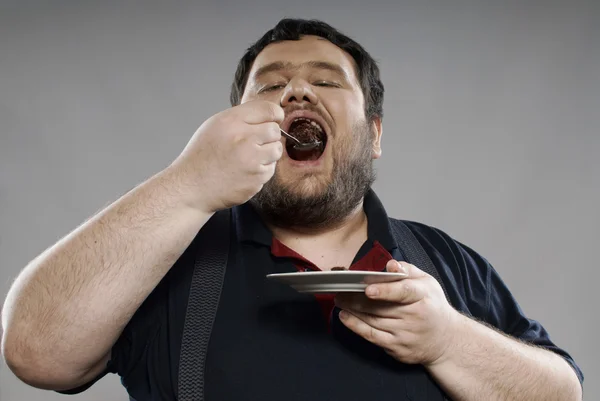 stock image Funny fat guy eating chocolate cake