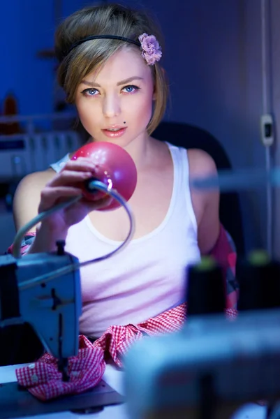 Seductive blond sewing in her workshop — Stock Photo, Image