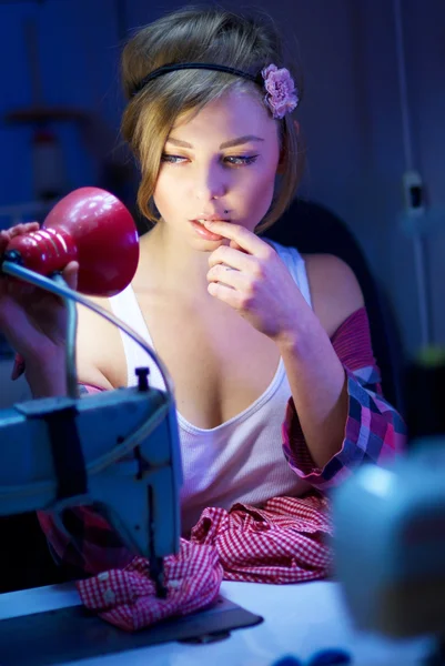 Seductive blond sewing in her workshop — Stock Photo, Image