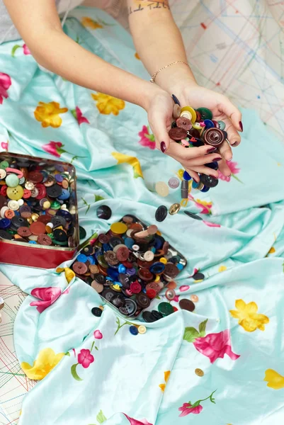 stock image Female hands spilling buttons