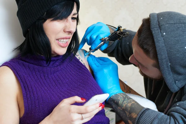 Emoções de uma menina ao fazer uma tatuagem — Fotografia de Stock