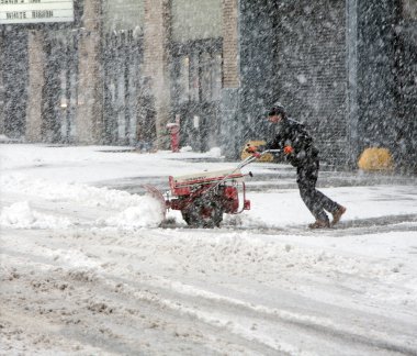 Man shoveling snow during snow storm clipart