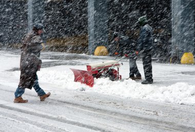 Shoveling snow in blizzard clipart