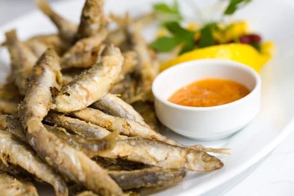 stock image Fried sprat with souce