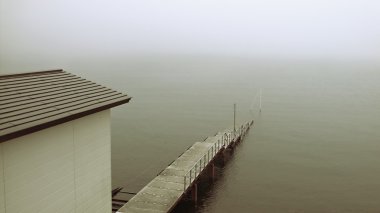 Old pier in mist clipart