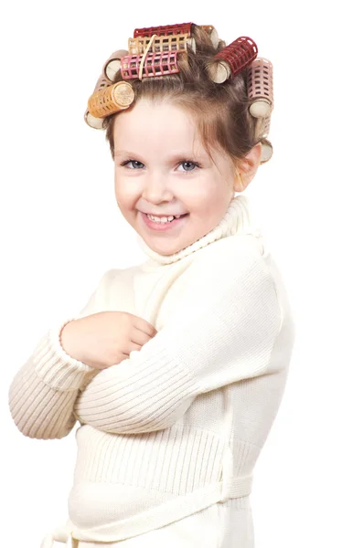 Beautiful little girl with curlers on her head. — Stock Photo, Image