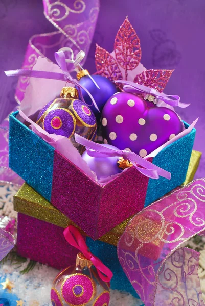 Colorful gift boxes with christmas baubles — Stock Photo, Image