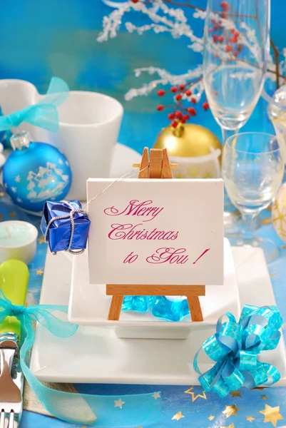 Christmas table with small easel on the plate — Stock Photo, Image
