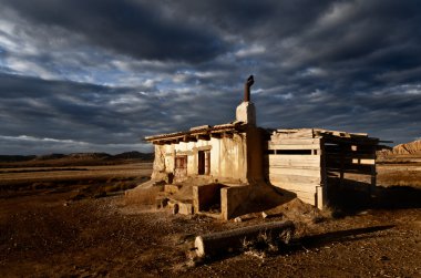 Abandoned rural house landscape dramatic cloud sky clipart