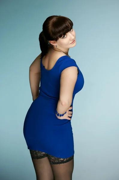 The beautiful brunette in a dark blue dress — Stock Photo, Image