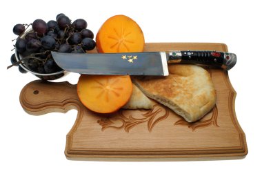 The Uzbek knife on a chopping board clipart