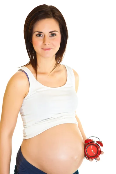 Gravid flicka med klocka på grund datum koncept — Stockfoto