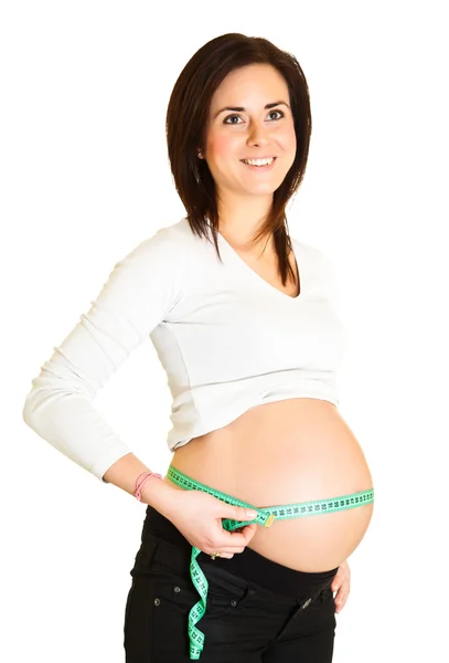 Pregnant woman measuring belly isolated on white — Stock Photo, Image