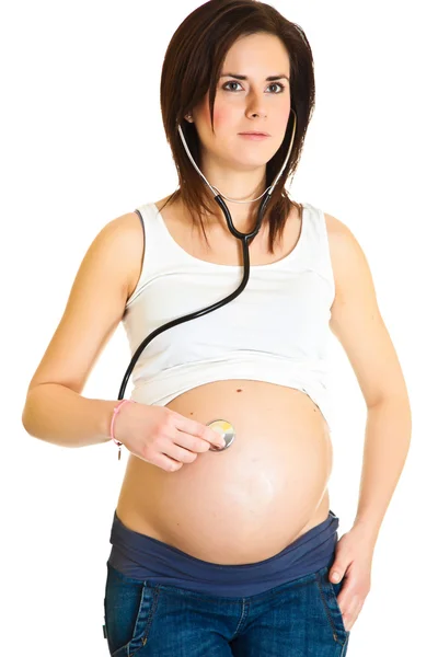 Pregnant woman examining belly with stethoscope isolated — Stock Photo, Image