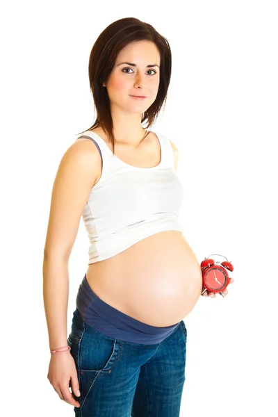 Gravid flicka med klocka på grund datum koncept — Stockfoto