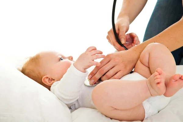 Mère auscultant mignon bébé fille isolé sur blanc — Photo