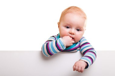 Isolated beaufiful caucasian infant baby behind whiteboard clipart