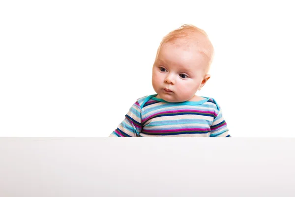 Isolated beaufiful caucasian infant baby behind whiteboard — Stock Photo, Image