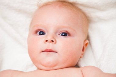 Mother creaming cute infant girl face