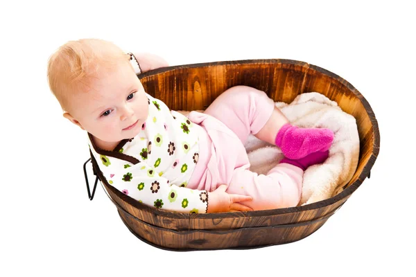 Cute infant girl sitting in wooden bucket — Stock Photo, Image
