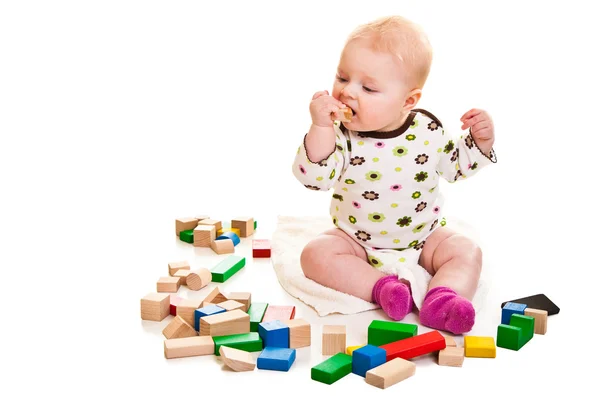 Infant girl playing with building bricks isolated on white — Stock Photo, Image