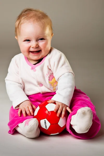 stock image Infant girl playing in room on wooden floor