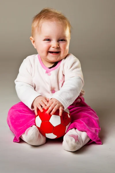 stock image Cute infant baby girl sitting on the floor