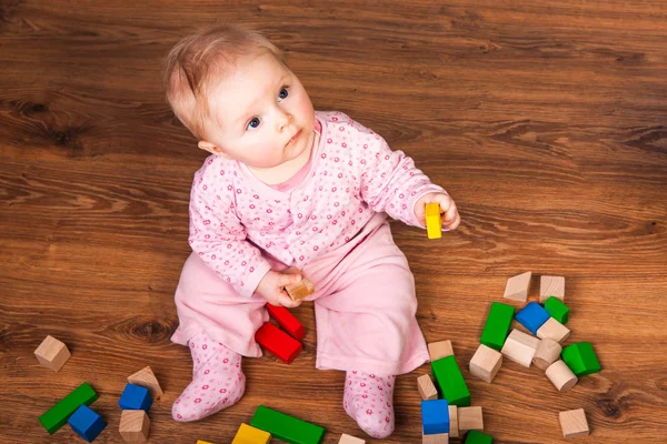 Baby meisje spelen in de kamer op houten vloer — Stockfoto