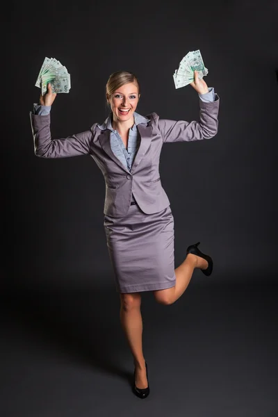 stock image Woman with polish zloty money on dark gray background