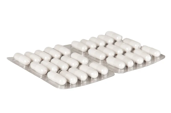 Pillole in blister su uno sfondo bianco — Foto Stock