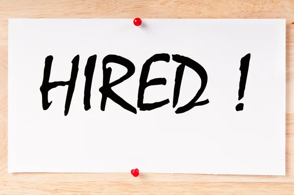 "Hired" written on paper — Stock Photo, Image