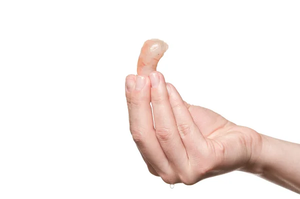 Рука тримає заморожені креветки проти білого — стокове фото