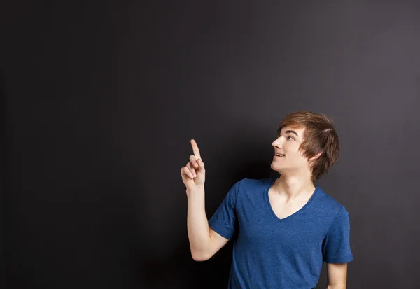 Young man over a chalk board — Stock Photo, Image