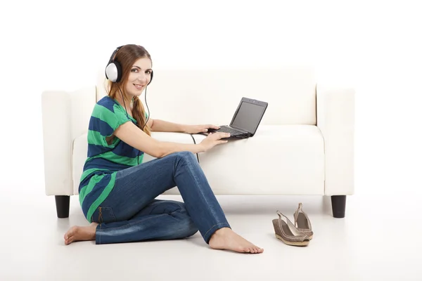 Listen music and using a laptop — Stok fotoğraf