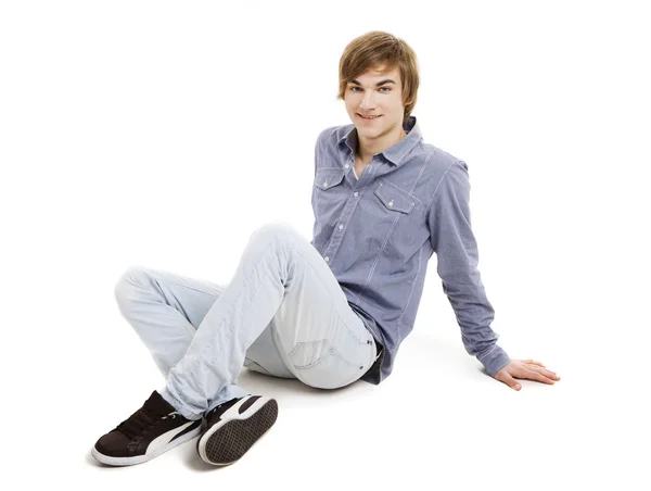 Young man sitting on the floor — Stock Photo, Image