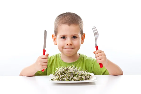 Kid taking green food — Stock Photo, Image