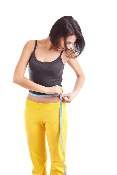 Kobieta mierzy talię — Zdjęcie stockowe
