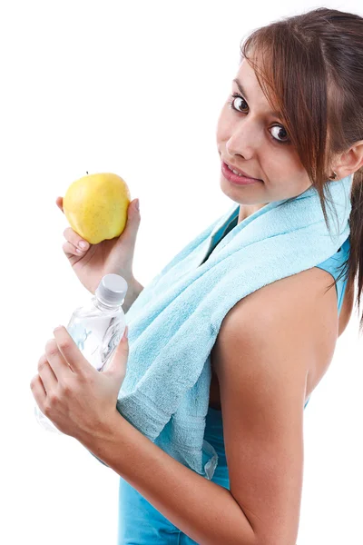 Kobieta trzyma butelkę wody i jabłko — Zdjęcie stockowe