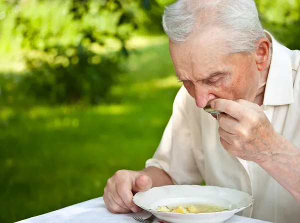 Senior man eating — Stock Photo, Image
