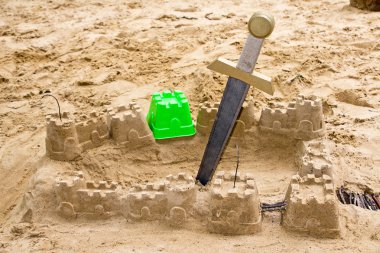 Sandcastle with a sword clipart