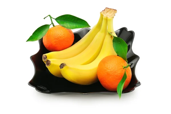 Tangerines and banana in a plate — Stock Photo, Image
