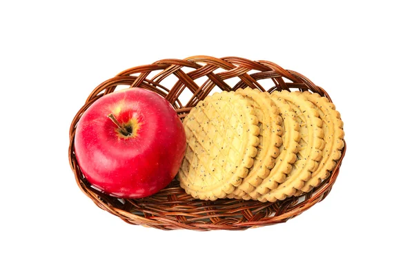 Jabłka i herbatniki w koszyku — Zdjęcie stockowe
