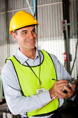 Technician taking machine gauge reading clipart