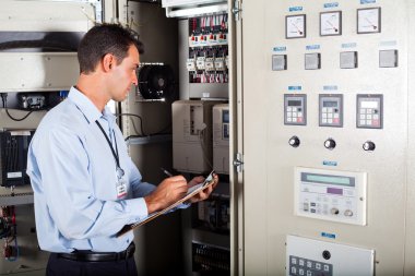 Technician writing down machine setting data clipart