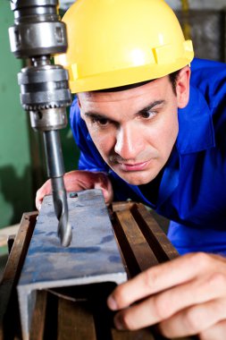 Factory worker using drilling machine clipart