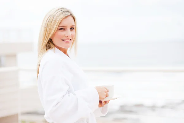 Young woman in bathrobe drinking coffee — Stock Photo, Image