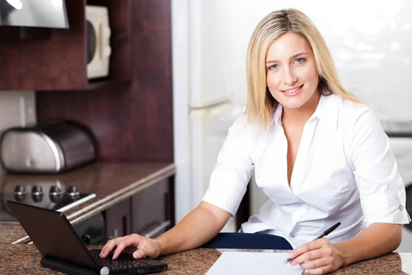Beautiful blonde woman working from home — Stock Photo, Image