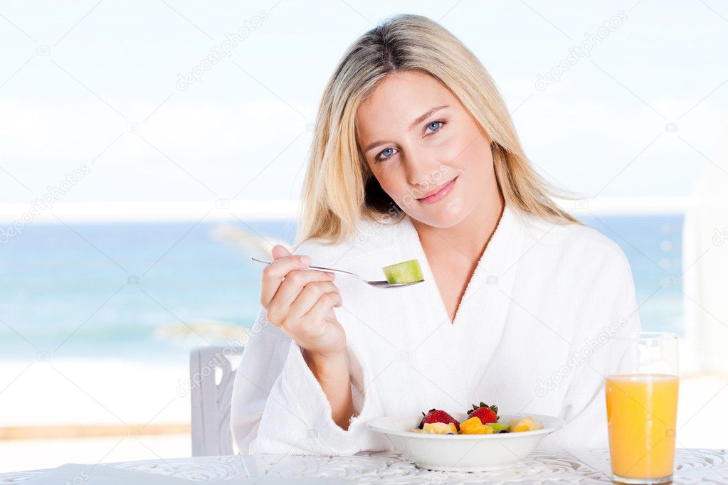 Young woman eating breakfast