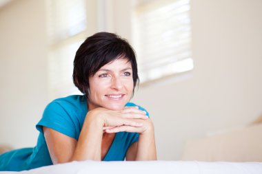 Middle aged woman daydreaming clipart